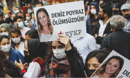  ?? (Umit Bektas/Reuters) ?? DEMONSTRAT­ORS CARRY pictures of Deniz Poyraz, who was killed in an attack on a local office of the pro-Kurdish Peoples’ Democratic Party (HDP), during a protest in Istanbul last week. The banner reads: ‘Deniz Poyraz is immortal.’