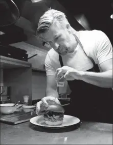  ?? PROVIDED TO CHINA DAILY ?? German chef Uwe Opocensky prepares a burger.