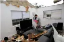  ?? Photograph: Paul Hennessy/Sopa Images/ Rex/Shuttersto­ck ?? Jose Pico sifts through the wreckage of his apartment which was destroyed after a tornado, spawned from Tropical Storm Cristobal, passed through Orlando, Florida.