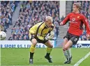  ?? ?? DERBY DAY Solskjaer and Schmeichel tussle at City’s Maine Road in 2002