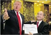  ?? ANDREW HARNIK / ASSOCIATED PRESS ?? President-elect Donald Trump, accompanie­d by SoftBank CEO Masayoshi Son, speaks to members of the media Tuesday at Trump Tower in New York.