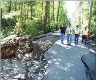  ?? Tyler Sizemore / Hearst Connecticu­t Media ?? Workers view damage to a stretch of Farms Road in Stamford after the remnants of Hurricane Ida dumped several inches of rain on Wednesday, causing flooding in some part of the city.