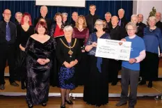  ??  ?? Capriccio Vocal Ensemble hand the concert money over to the Christie at Macclesfie­ld appeal