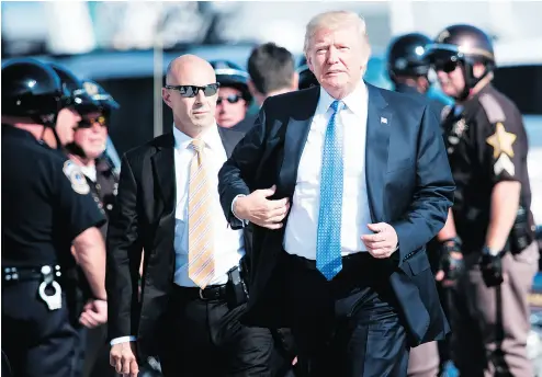  ?? BRENDAN SMIALOWSKI / AFP / GETTY IMAGES ?? U. S. President Donald Trump with motorcycle police escorts Wednesday at Indianapol­is Internatio­nal Airport.