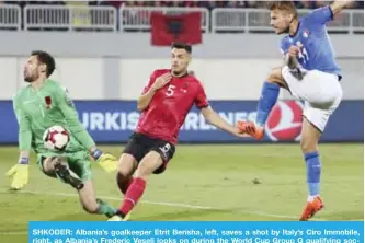  ??  ?? SHKODER: Albania’s goalkeeper Etrit Berisha, left, saves a shot by Italy’s Ciro Immobile, right, as Albania’s Frederic Veseli looks on during the World Cup Group G qualifying soccer match between Albania and Italy at Loro Borici stadium, in Shkoder. — AP