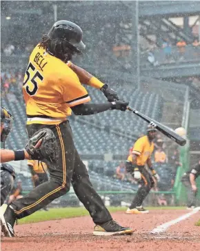  ?? CHARLES LECLAIRE / USA TODAY SPORTS ?? Pirates first baseman Josh Bell hits the winning double against the Brewers during the 10th inning Sunday.