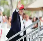  ??  ?? NEW JERSEY: US President Donald Trump waves to spectators at the Trump National Golf Club during the third round of the US Women’s Open Golf tournament in Bedminster, New Jersey.—AP