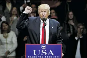  ?? The Associated Press ?? TRUMP: President-elect Donald Trump raises his fist as he speaks during the first stop of his post-election tour on Thursday in Cincinnati.