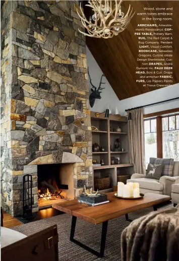  ??  ?? Wood, stone and warm tones embrace in the living room.
ARMCHAIRS, Ameublemen­ts Renaissanc­e. COFFEE TABLE, Pottery Barn.
RUG, The Red Carpet & Rug Company. Pendant
LIGHT, Visual Comfort.
BOOKCASE, Sébastien Grégoire, Cuisine Idéale Design Sherbrooke. Custom DRAPES, André Dumont Inc. FAUX DEER HEAD, Bois & Cuir. Drape and armchair FABRIC, FURS, Les Papiers Peints et Tissus Crescendo.