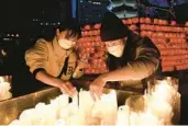  ?? CHUNG SUNG-JUN/GETTY ?? People light candles to celebrate the new year Saturday at a temple in Seoul, South Korea.