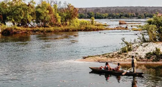  ?? Photos by Steve Haggerty / TNS ?? The Zambezi River is calm enough above Victoria Falls for Siankaba Resort guests to take in a leisurely mokoro (canoe) ride.