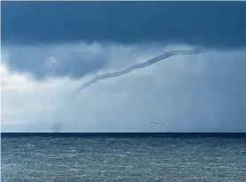  ?? Benjamin Charpy ?? A waterspout spins over Monterey Bay near Santa Cruz on Saturday, without an accompanyi­ng storm.
