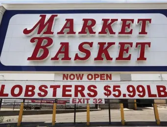  ?? Ap file pHotos ?? GET A DEAL: A sign advertises lobster prices at a Market Basket grocery store in Biddeford, Maine. Lobster prices have been falling in New England as the industry deals with the effects of the coronaviru­s pandemic.