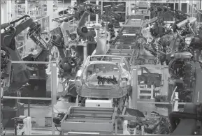  ?? TRIBUNE NEWS SERVICE ?? Robots are used extensivel­y on the assembly line at the Tesla auto plant in Fremont.