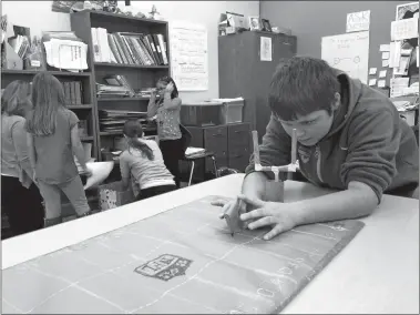  ?? DEBORAH STRASZHEIM/THE DAY ?? Chandler Metivier, 10, plays the cardboard video game he helped build at Catherine Kolnaski Magnet School in Groton.