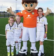  ??  ?? Clodagh Galvin, age 7, of Arrow Harps, Shauna McCormack, age 8, of Ballymote Celtic, and Martha-Kate McCarthy, age 9, of Boyle Celtic, wit mascot Cara during the Aviva Soccer Sisters Golden Camp.