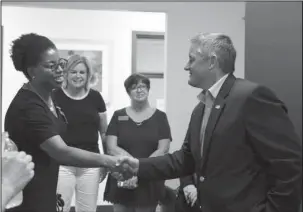  ?? The Sentinel-Record/Grace Brown ?? CONGRESSIO­NAL VISIT: U.S. Rep. Bruce Westerman, R-District 4, left, shakes hands with Lyniya Johnson, an investigat­or with the Arkansas State Police Crimes Against Children division, while touring the Cooper-Anthony Mercy Child Advocacy Center on Monday. Westerman earlier attended a Coffee with a Congressma­n event at The Greater Hot Springs Chamber of Commerce.