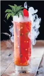 ??  ?? A smoke-infused cocktail