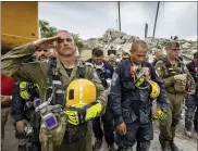  ?? JOSE A IGLESIAS — VIA THE ASSOCIATED PRESS ?? A prayer ceremony Wednesday in front of the rubble that once was Champlain Towers South in Surfside, Fla. Members of search-and-rescue teams and Miami-Dade Fire rescue, along with police and workers who have been toiling at the site of the collapse, gathered for the moment of prayer and silence.