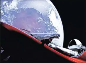  ??  ?? This still image taken from a SpaceX livestream video shows Starman sitting in SpaceX CEO Elon Musk’s cherry red Tesla roadster after the Falcon Heavy rocket delivered it into orbit around the Earth on Tuesday.