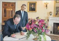  ?? AP PHOTOS ?? In this 2014 photo provided by Stichting Kunstboek, French President Francois Hollande signs the guest book as President Obama looks on at the White House in Washington. For the state visit, a centerpiec­e bouquet of early spring flowers in the French...