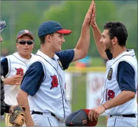  ?? For Montgomery Media / MARK C. PSORAS ?? Doylestown starting pitcher Jason Goldberg congratula­tes closer Marty Martens after shutting down Spring City in the eighth inning of their Pennslyvan­ia American Legion State Championsh­ip contest at Boyertown.