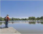  ??  ?? Moe Perez fishes at the Humboldt Park Lagoon last week.
ANTHONY VAZQUEZ/SUN-TIMES