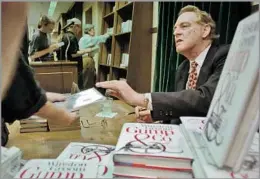  ?? Anders Krusberg Associated Press ?? ‘IT TOUCHED A NERVE’
Winston Groom signs copies of “Gump & Co.,” his 1995 follow-up to “Forrest Gump,” which won six Oscars and became a pop culture phenomenon.