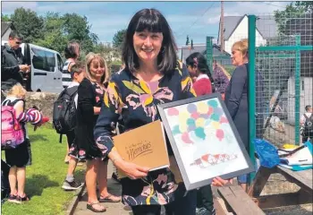  ??  ?? Catriona Smith with a number of gifts and mementos she received from parents, pupils and colleagues.