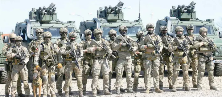  ?? — Reuters ?? Members of Austrian special operations unit Jagdkomman­do stand during an exercise in Wiener Neustadt, Austria, on Friday.