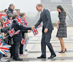  ??  ?? The Royal couple meet school children in Trocadero Square near the Eiffel Tower