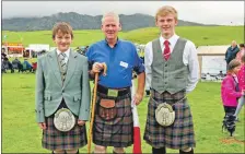  ??  ?? Chairman of the games, Allan MacDonald, with piping brothers Sandy and Finlay Cameron from Spean Bridge. Finlay received the Cameron-Head cup for junior piping. 21_ F32 Arisaig Games_ chairman of the games 01