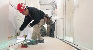  ?? STEVE RUSSELL PHOTOS TORONTO STAR ?? Work continues to connect new cables from the reconstruc­ted electrical room to each unit in the building.