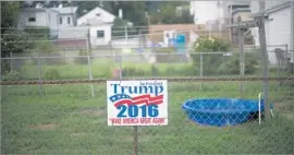  ?? Mark Makela Getty Images ?? A YARD in Schuylkill Haven, Pa. Many people in rural areas of swing states like Pennsylvan­ia would pay thousands more for insurance under the Republican plan.