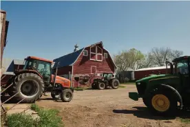  ??  ?? Tractors sit outside a barn at a cattle farm in Hinton, Plymouth county, Iowa. Photograph: Dan Brouillett­e/Bloomberg /Getty Images