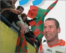  ?? Photo by David Maher, Sportsfile. ?? Ó Cinnéide celebrates with An Ghaeltacht fans after qualifying for the 2004 All-Ireland final.