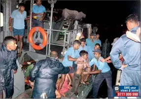  ??  ?? Sailors assist a rescued boy to disembark from a Navy vessel at Oluvil fisheries harbour yesterday morning. Picture courtesy Sri Lanka Navy