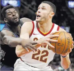  ?? Tony Dejak ?? The Associated Press Cavaliers forward Larry Nance Jr. eyes the basket against Pistons forward James Ennis in the first half of Cleveland’s 112-90 win Monday at Quicken Loans Arena.