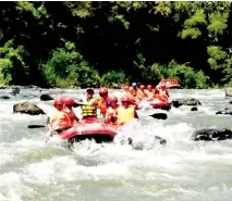  ??  ?? The Kampung Sungoi Youth Club rafting in the Pegalan River during the Sayang Sungai programme.