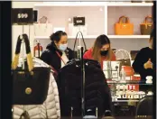  ??  ?? Customers shop for jewelry at the Michael Kors store in the Vacaville Premium Outlet early Friday morning.