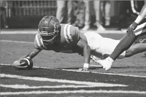  ?? ROGELIO V. SOLIS/AP ?? MISSISSIPP­I QUARTERBAC­K MATT CORRAL (2) stretches over the goal line for a seven-yard touchdown run against Arkansas during the first half of a game Saturday in Oxford, Miss.