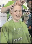  ?? HELENA OLIVIERO / HOLIVIERO@AJC.COM ?? Elyse Bryson had her head shaved at Fado Irish Pub in Buckhead to raise awareness and money for childhood cancer research. Bryson is a physician assistant at the Aflac Cancer Center at Children’s Healthcare of Atlanta.