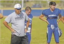  ?? LUIS SÁNCHEZ SATURNO/NEW MEXICAN FILE PHOTO ?? St. Michael’s head coach Joey Fernandez works with his team in August. Fernandez will likely be remembered as the greatest football coach in Northern New Mexico, and one of the best the state has ever seen.