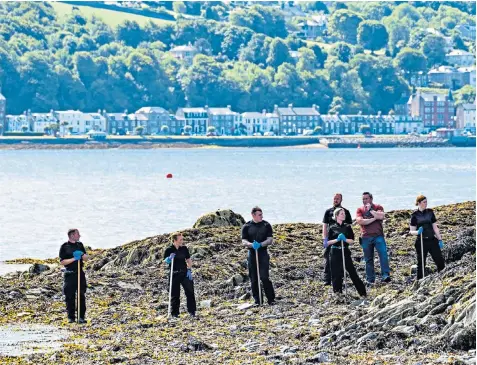  ??  ?? Police search the shoreline opposite the Rothesay home of Alesha Mcphail’s grandparen­ts, where the schoolgirl had been staying with her father