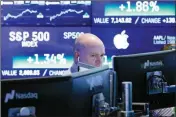  ?? ASSOCIATED PRESS ?? IN THIS FEB. 14 FILE PHOTO, a Nasdaq employee works at his computer at the Nasdaq MarketSite, in New York. On Thursday, March 8, the Federal Reserve reports on household wealth for the October-December quarter.