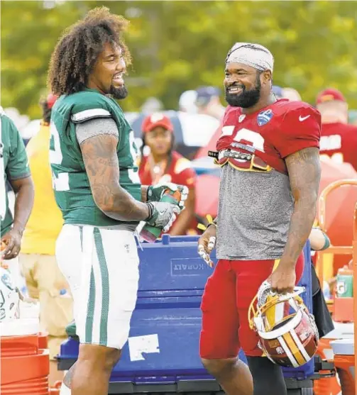  ?? Jets’ Leonard Williams greets Washington’s Zach Brown before day takes a nasty turn at joint practice in Richmond, Va. AP ??