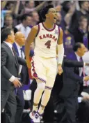  ?? ORLIN WAGNER/ THE ASSOCIATED PRESS ?? Kansas guard Devonte’ Graham (4) celebrates a three-point basket during overtime against West Virginia in Lawrence, Kan. on Monday. Kansas rallied from a 14-point deficit late in the second half to defeat West Virginia 84-80 in overtime.