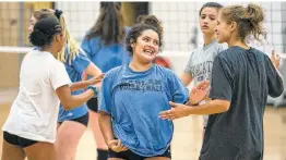  ?? Photos by Josie Norris / Staff photograph­er ?? Iliziah Martinez (left) encourages Camryn Salinas during volleyball team tryouts Aug. 2 at Harlan High School. Martinez is a defensive specialist.