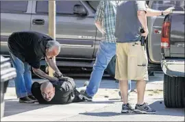  ?? Irfan Khan Los Angeles Times ?? RECOVERY AGENT Marc Bender, shown taking a man into custody, said that for many bounty hunters, “there is a lot of incentive to cut corners.”