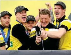  ?? PHOTO: AAP ?? ROAR EMOTION: Tigers stars Dustin Martin and Jack Riewoldt celebrate their success with coach Damien Hardwick.